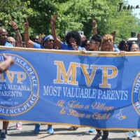 A group of people on a lawn with an MVP banner