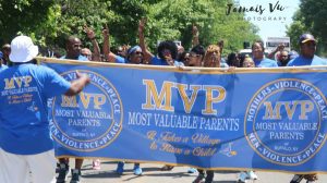 A group of people on a lawn with an MVP banner