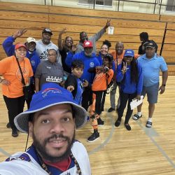 Volunteers and staff posing for picture at Neal Dobbins Inner City Basketball League